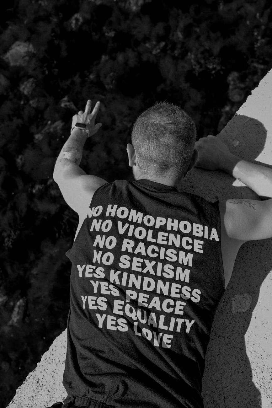 grayscale photo of man in sleeveless shirt