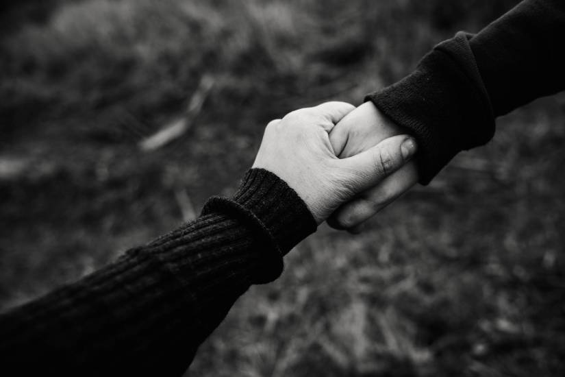 black and white photo of holding hands