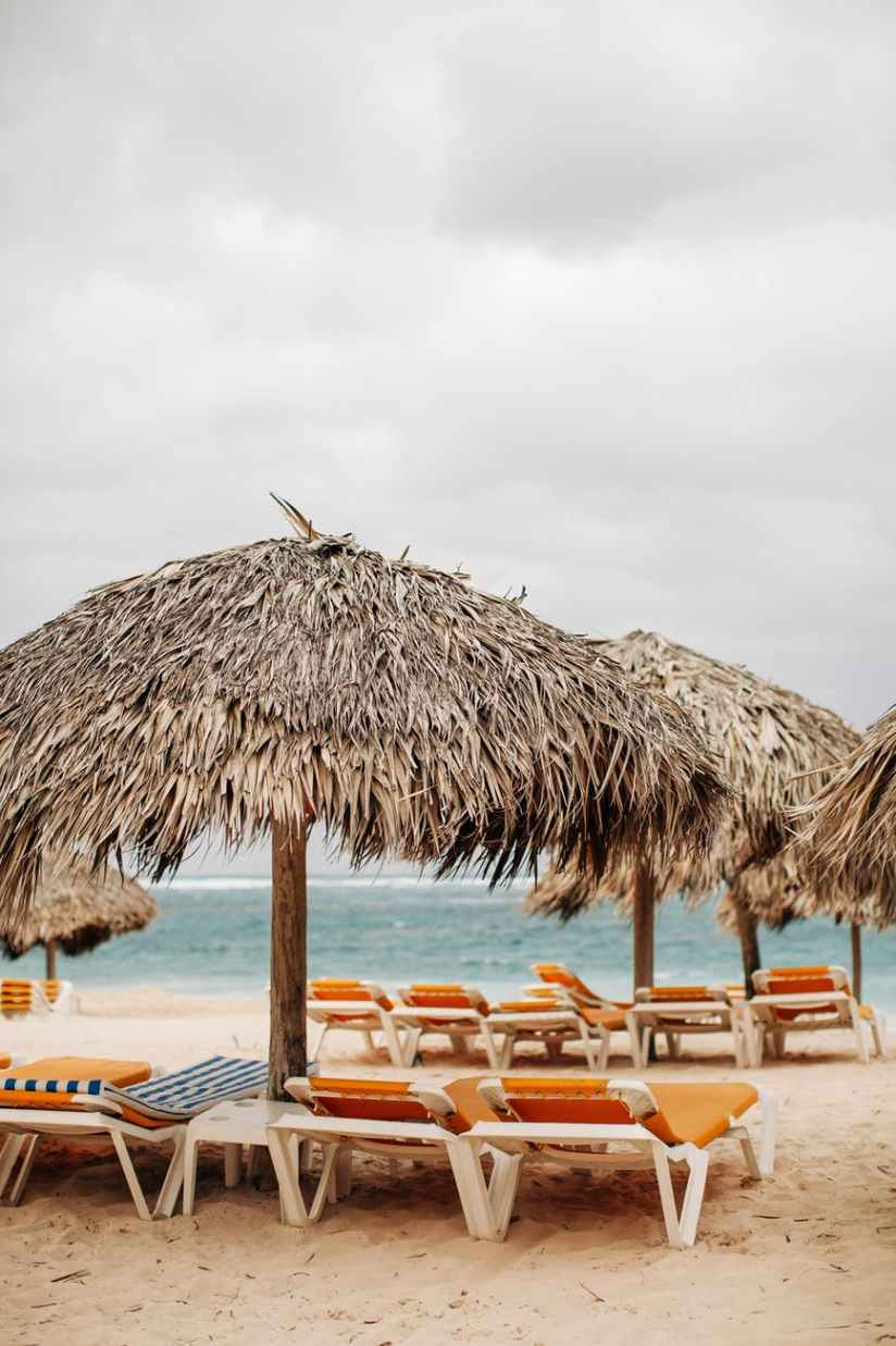 photo of nipa umbrellas on beach